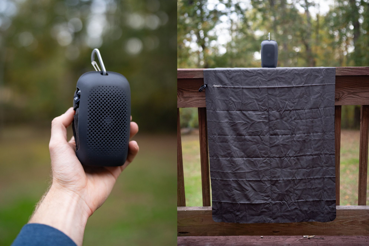 A large bathroom-sized travel towel is hung out to dry on a railing.