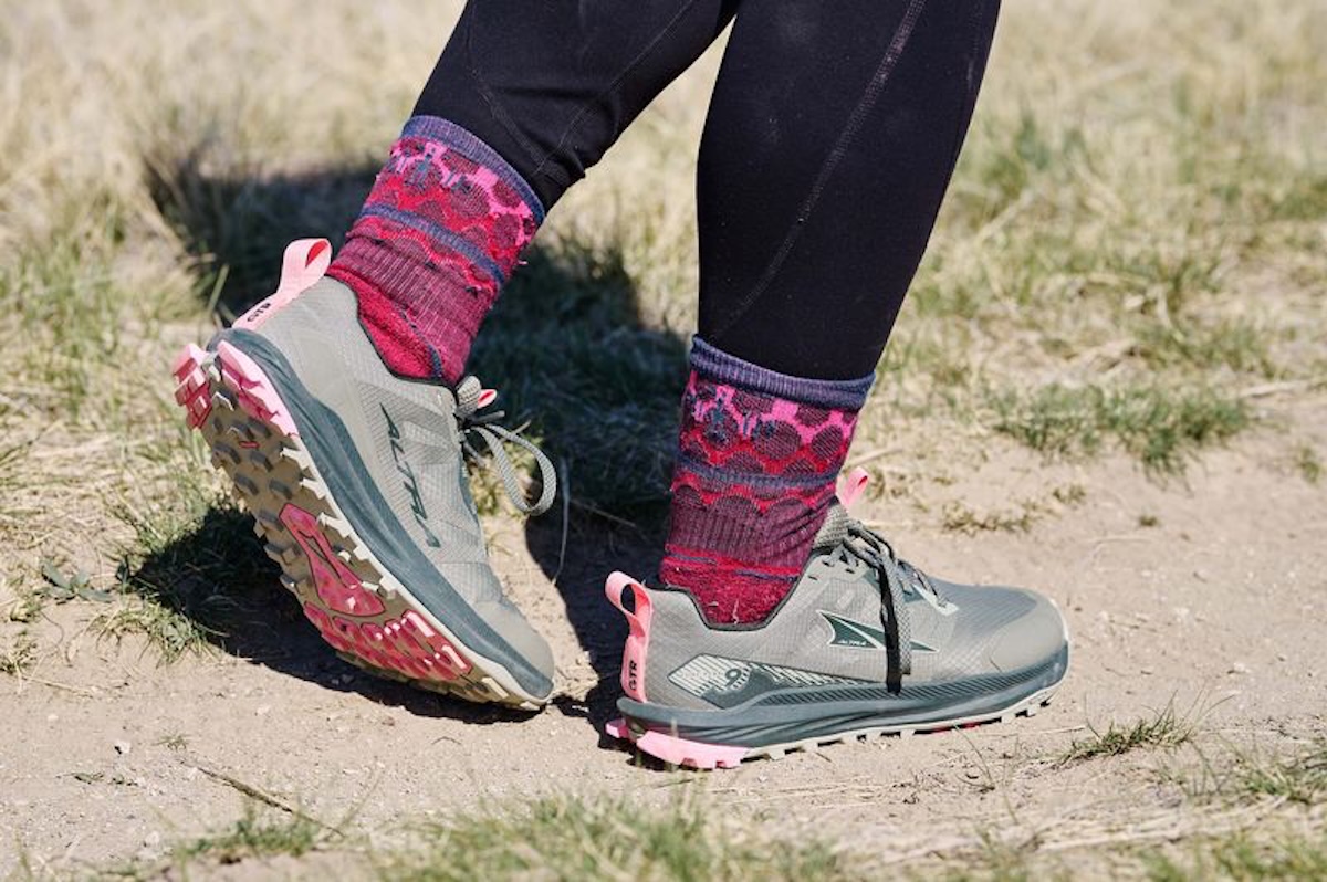 A close-up shot of the Altra Lone Peak 9 walking down the trail