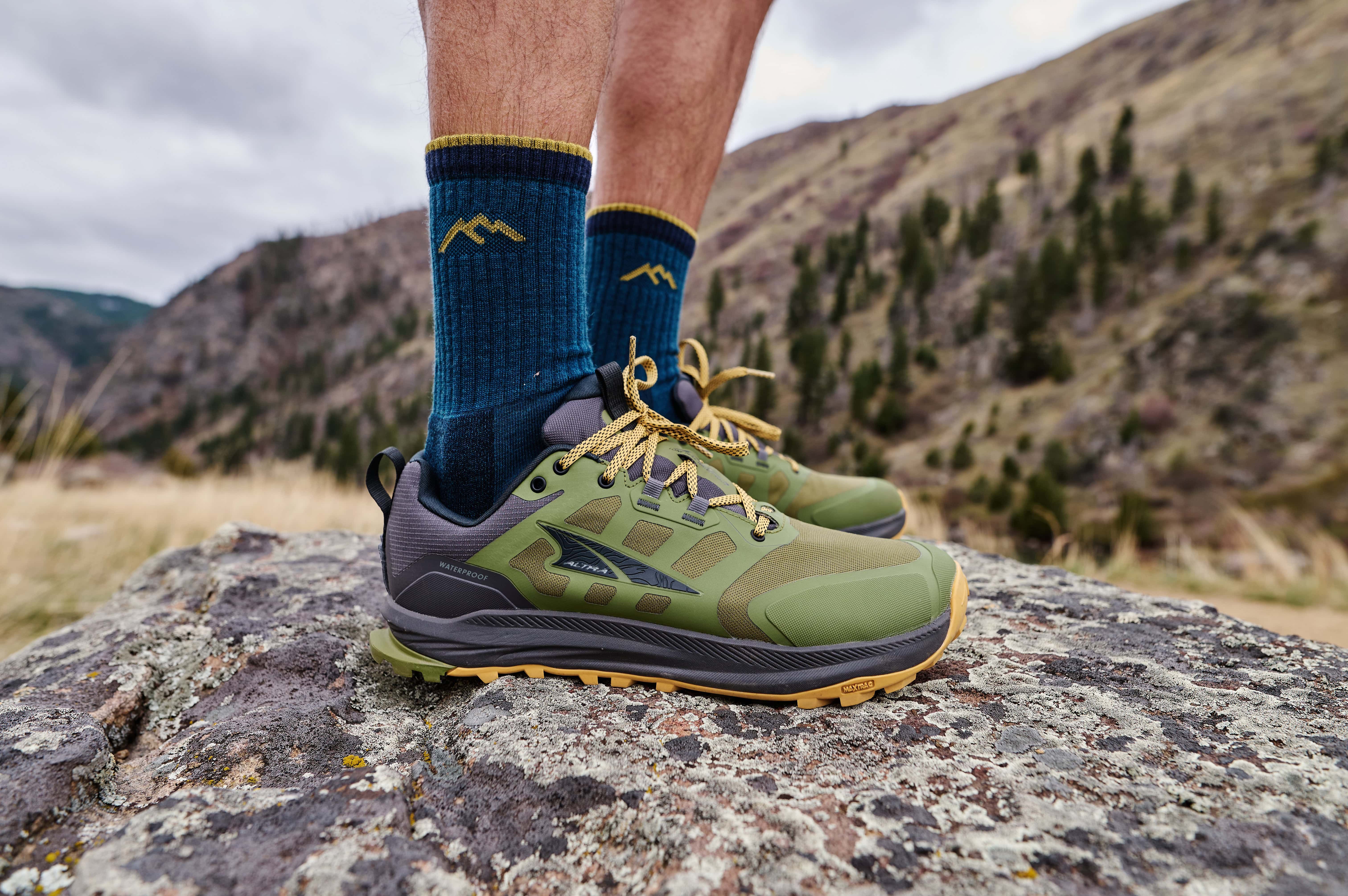 A side view of a man's lower legs and calves wearing the Altra Lone Peak 9 waterproof shoes