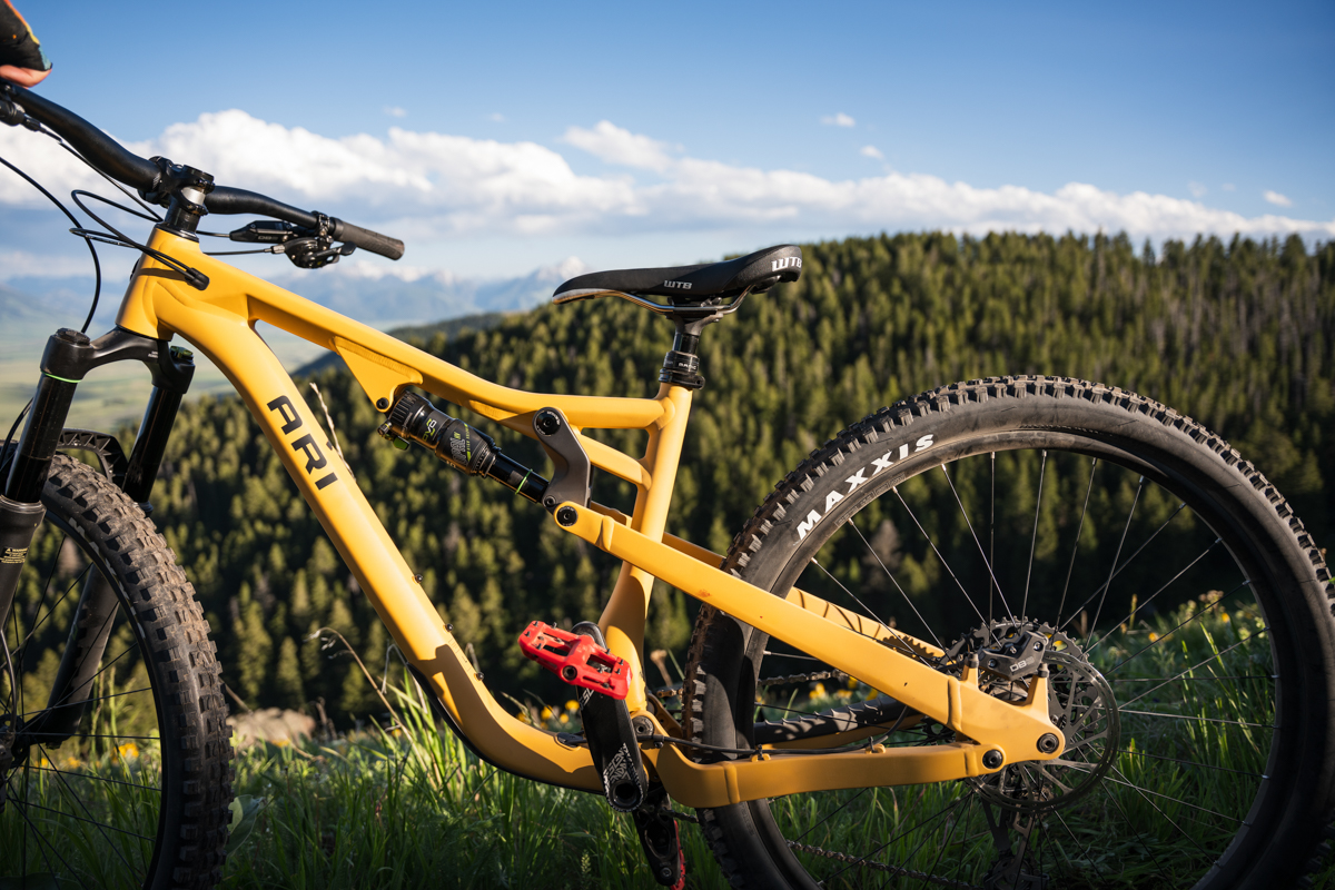 A close up of a yellow mountain bike on a sunny day