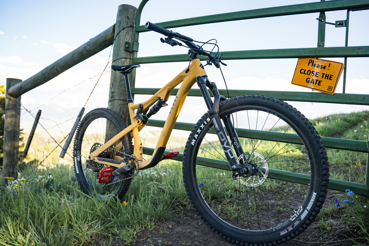 A close up of the front wheel on a yellow mountain bike