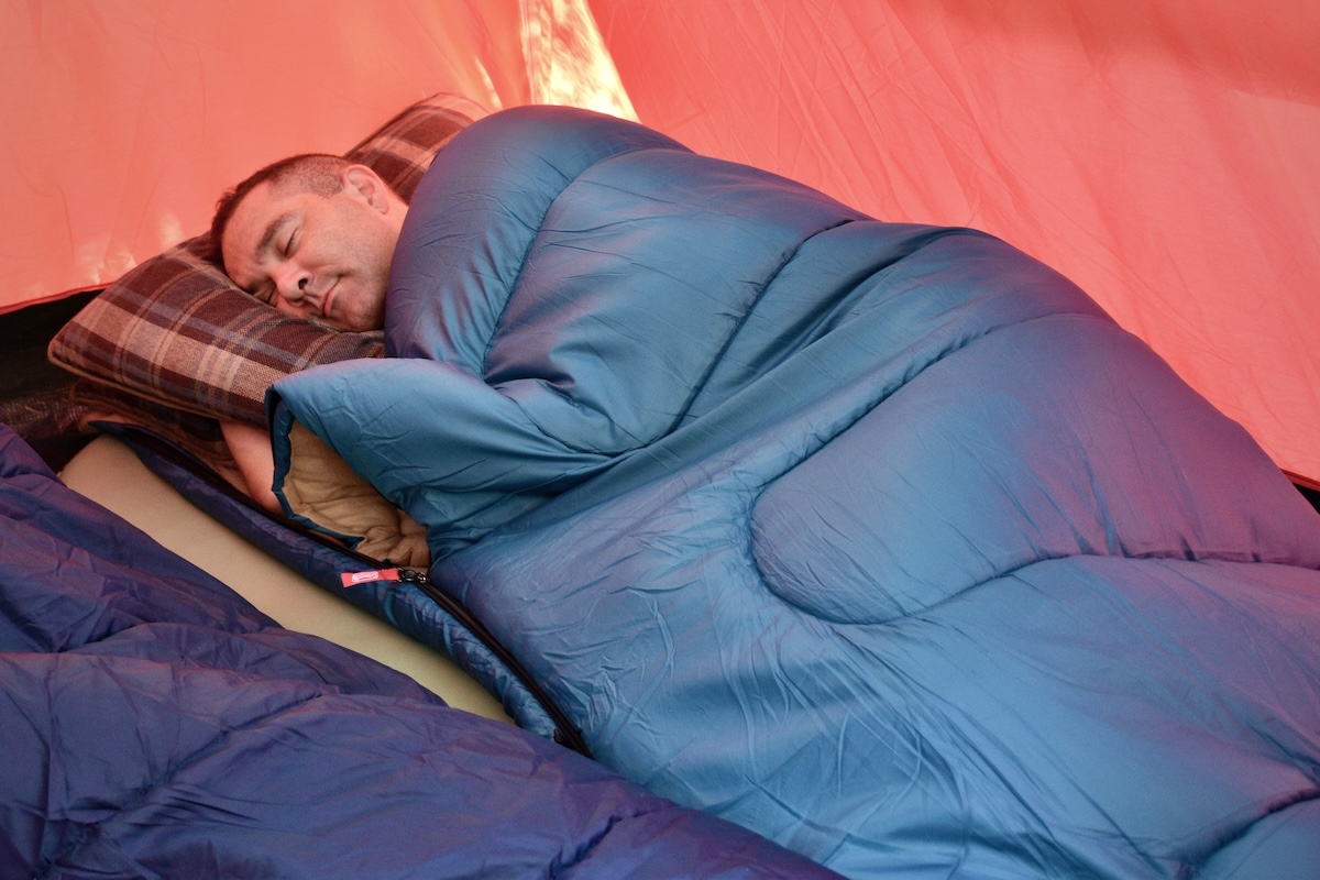 A man drifts off to sleep in the Coleman Brazos 20 Sleeping Bag