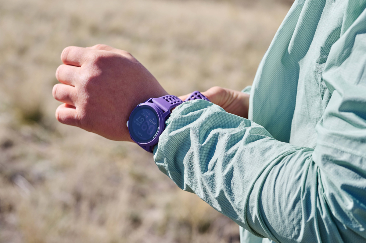A closeup of a purple fitness watch on a wrist