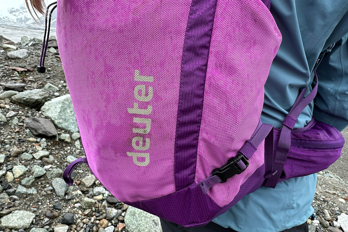 A close up of water soaking through a purple daypack