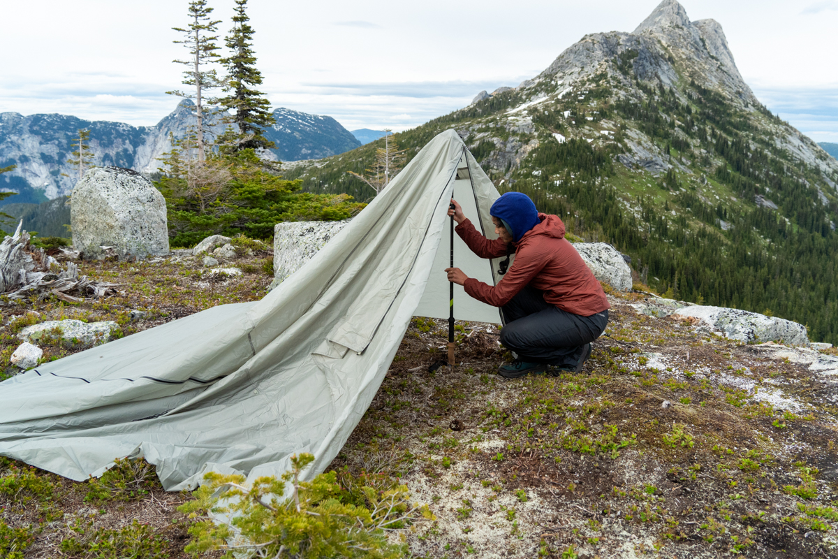 A woman pitching a backpacking tent
