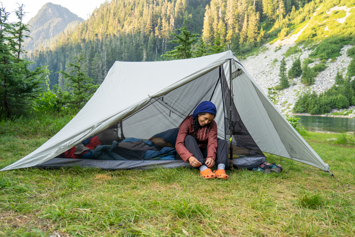 A woman sitting inside a backpacking tent