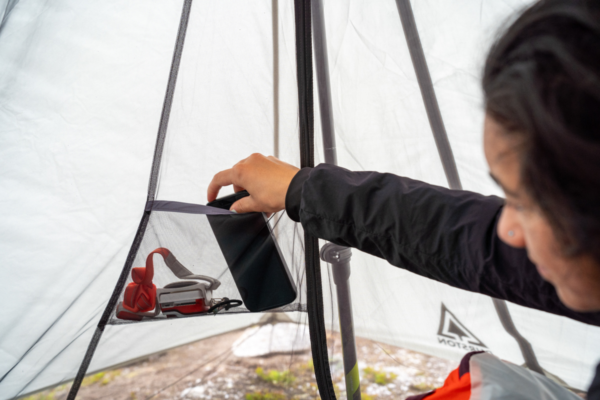 Putting a phone in a pocket inside a backpacking tent