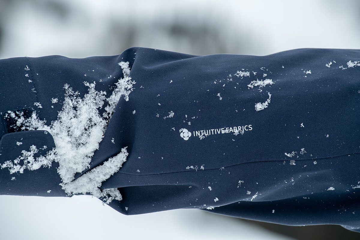 A closeup of the fabric on the Flylow Lucy jacket covered in snow