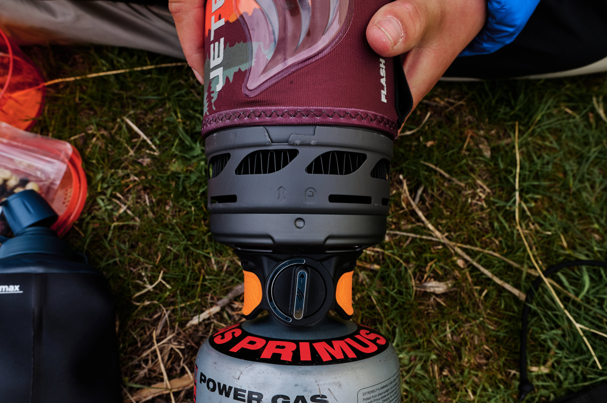 A close up of the pot and stove connection on a backpacking stove