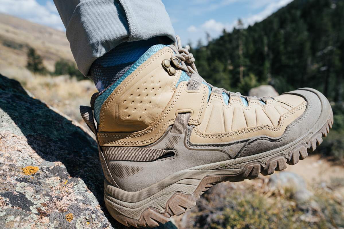A close up of a single brown leather waterproof hiking boot