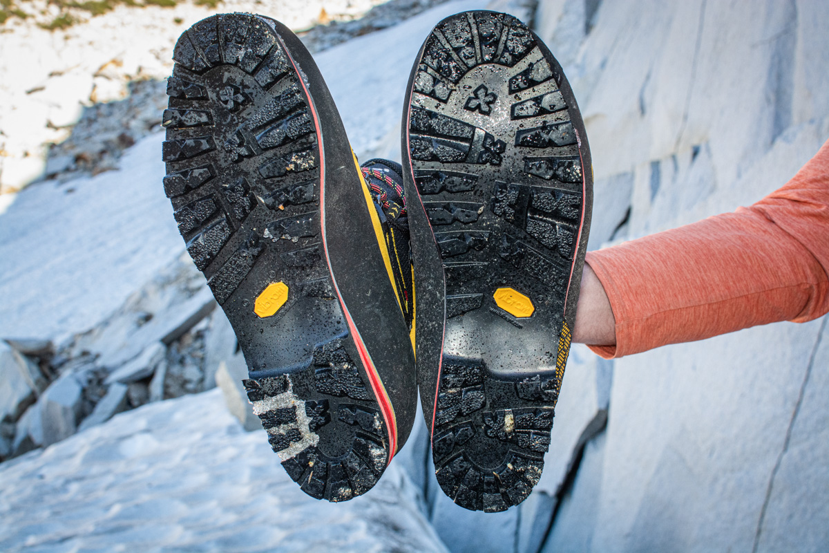 A man shows the outsole of the La Sportiva Nepal Cube GTX boots