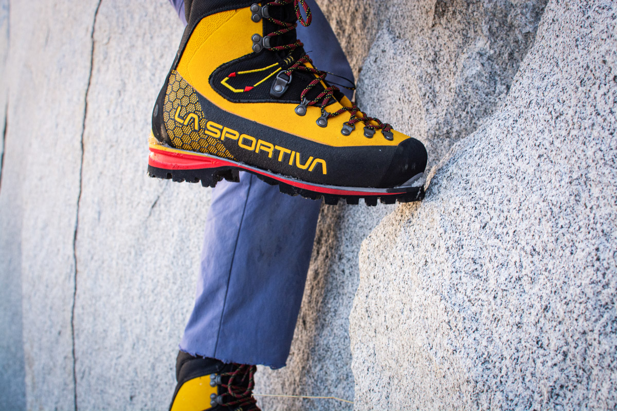 A closeup photo of the La Sportiva Nepal Cube GTX toeing into a cliff face