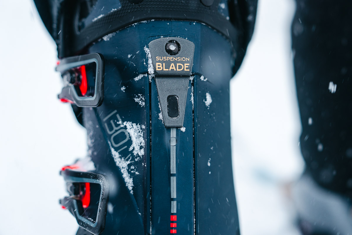 A close up of the suspension blade on the back of a ski boot