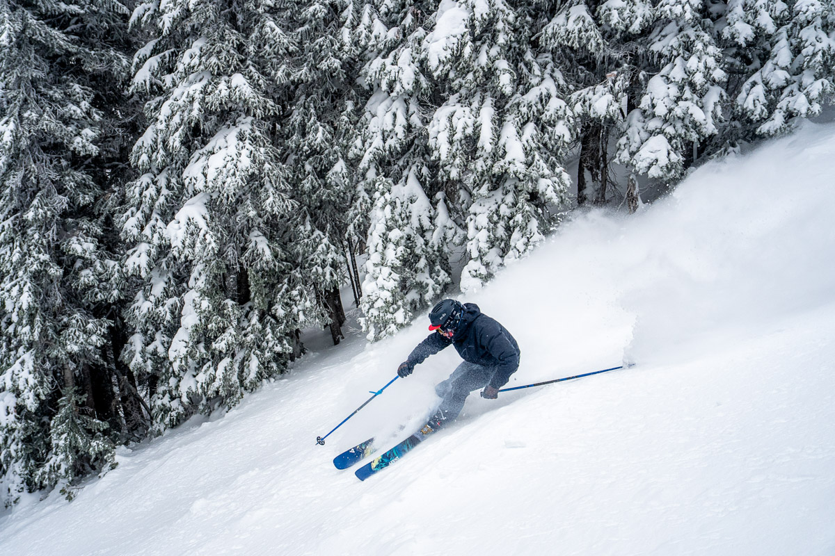 A skier coming down a powdery slope at high speed