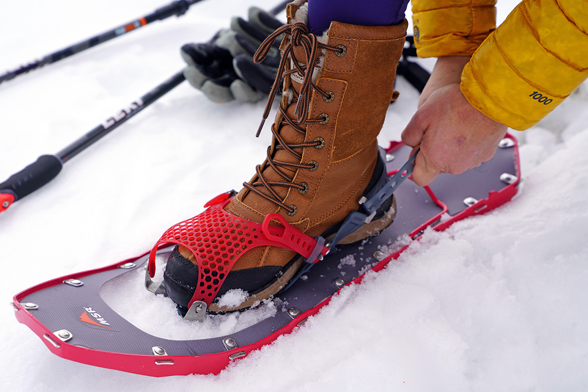 Tightening the binding on a snowshoe