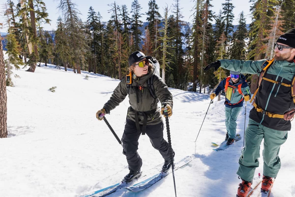 On the skin track with friends wearing the DAS Light Hoody