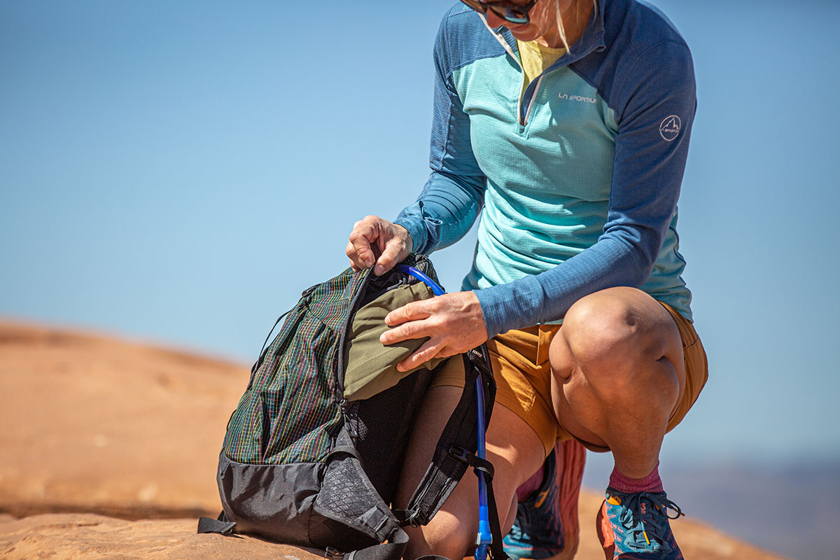 REI Co-op Flash 22 daypack (reaching into side pocket)