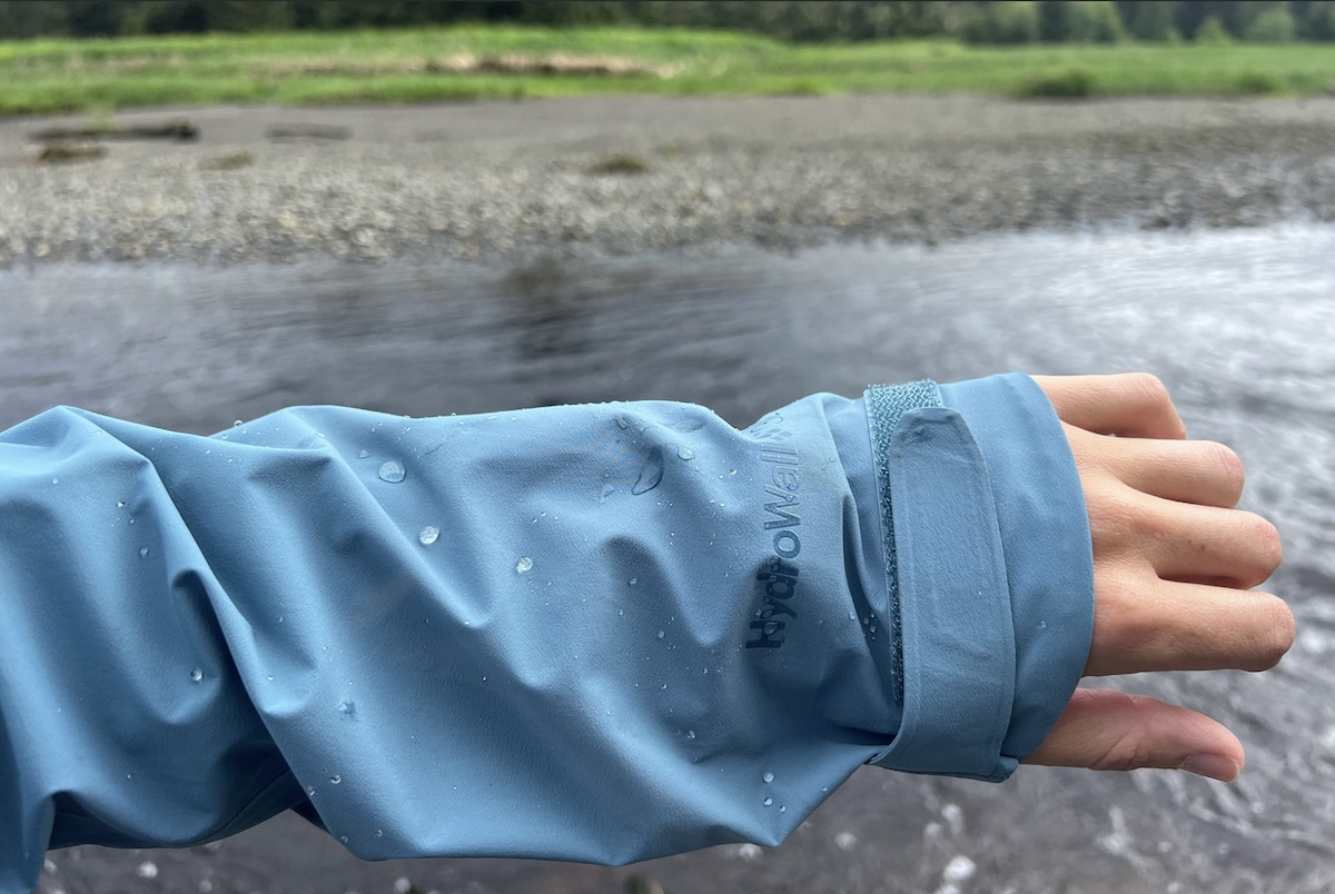 REI co-op XeroCloud rain jacket - water beading off the sleeve
