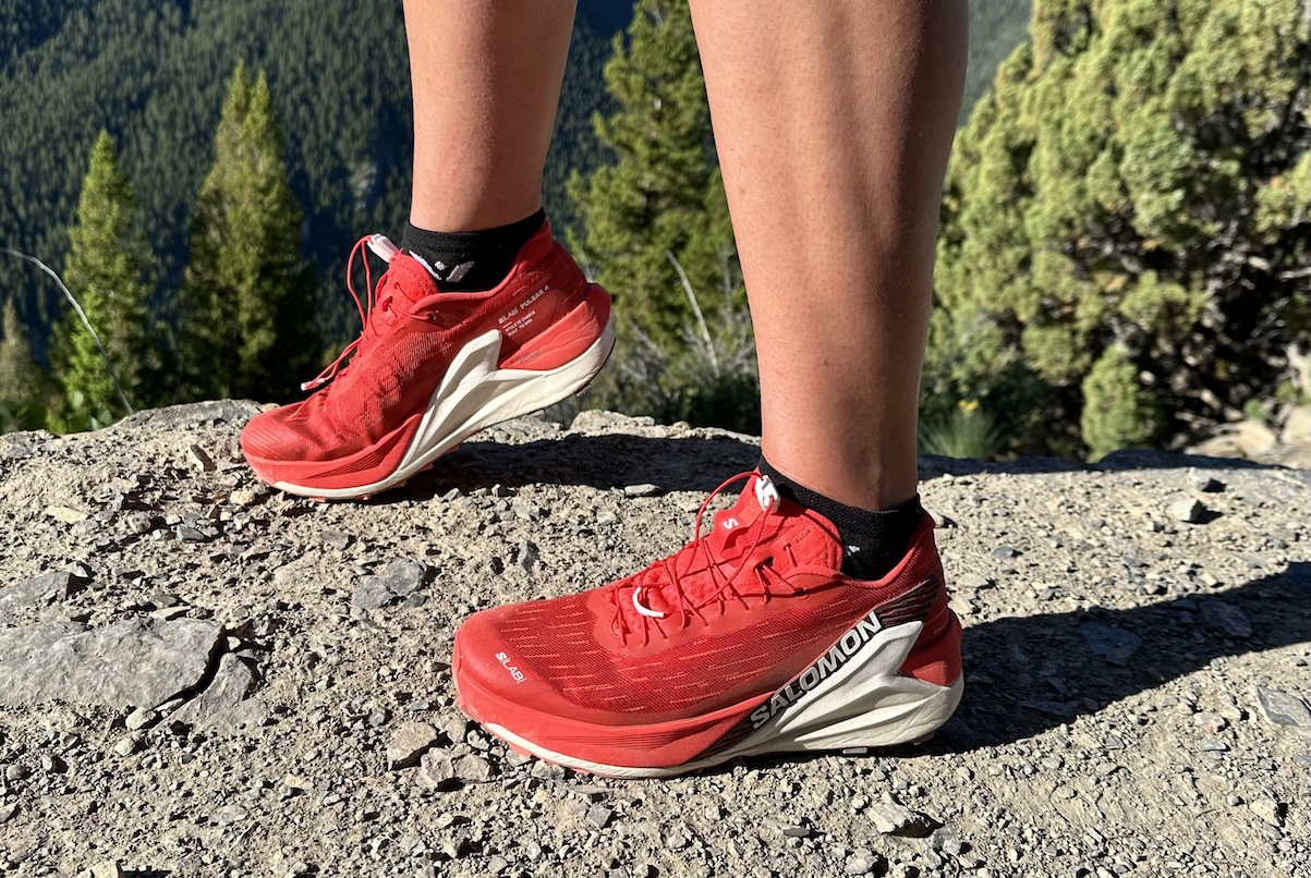 a pair of red shoes on a dry dirt trail 