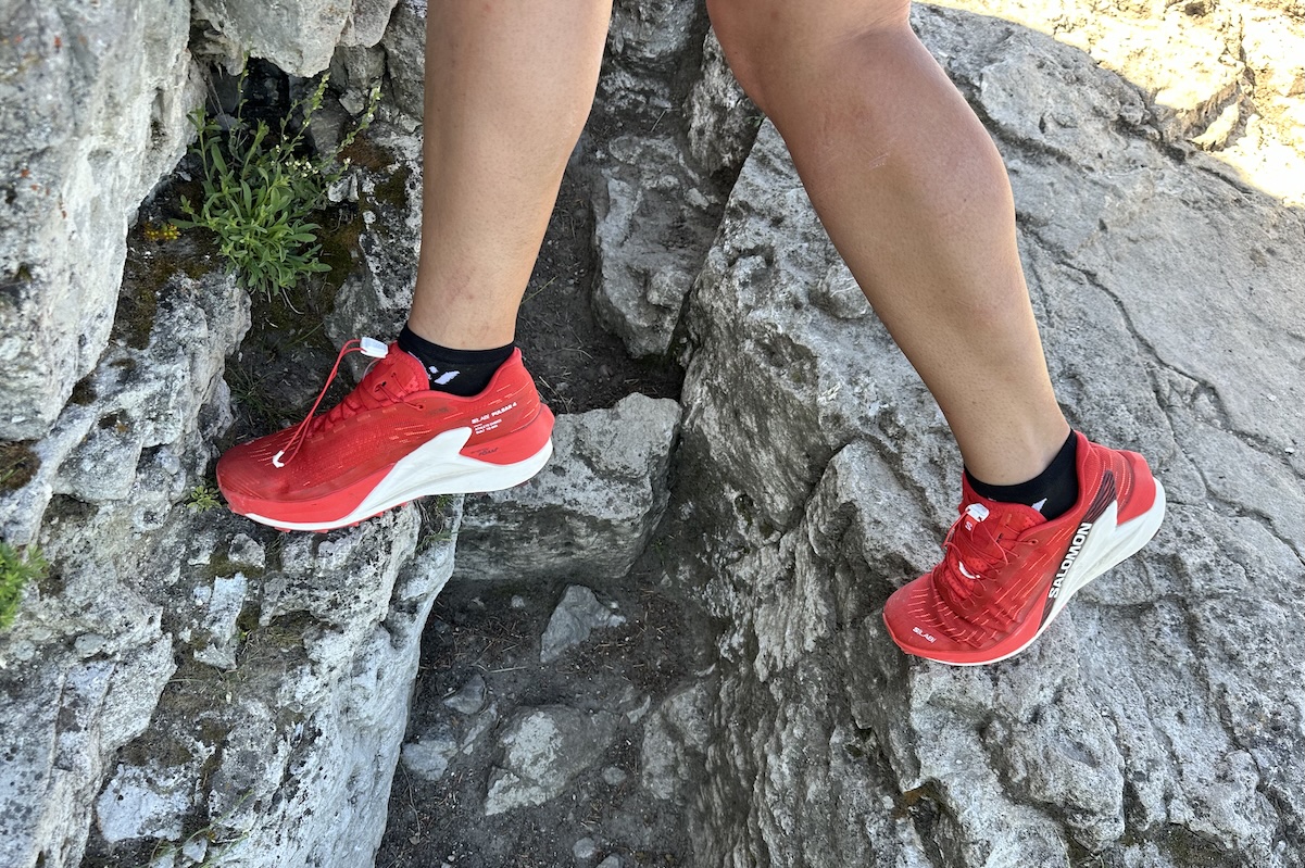 running on rocks in a pair of red salomon shoes 