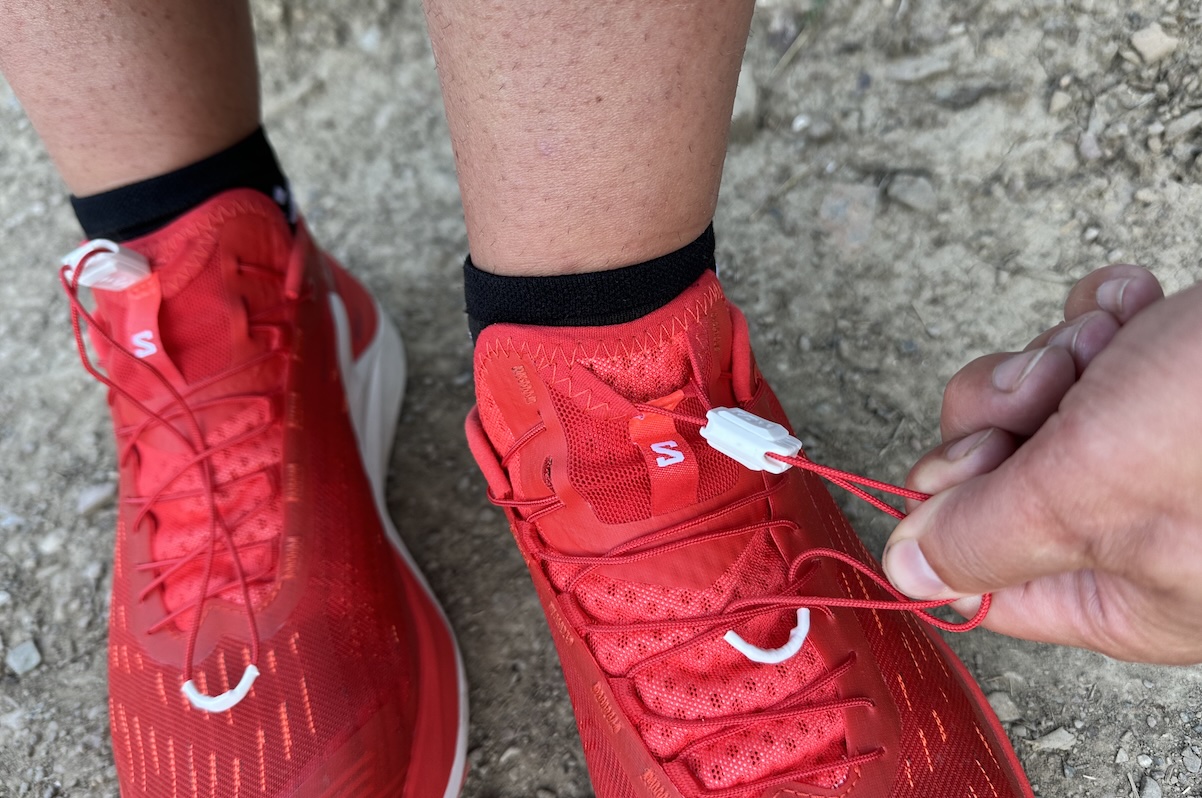 tightening the laces on a pair of red shoes 