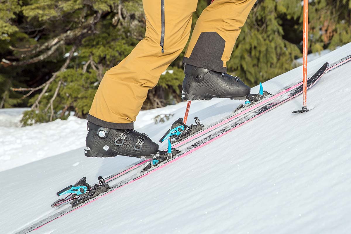 A skier skinning uphill with the Salomon SLab Shift MNC 13 ski bindings