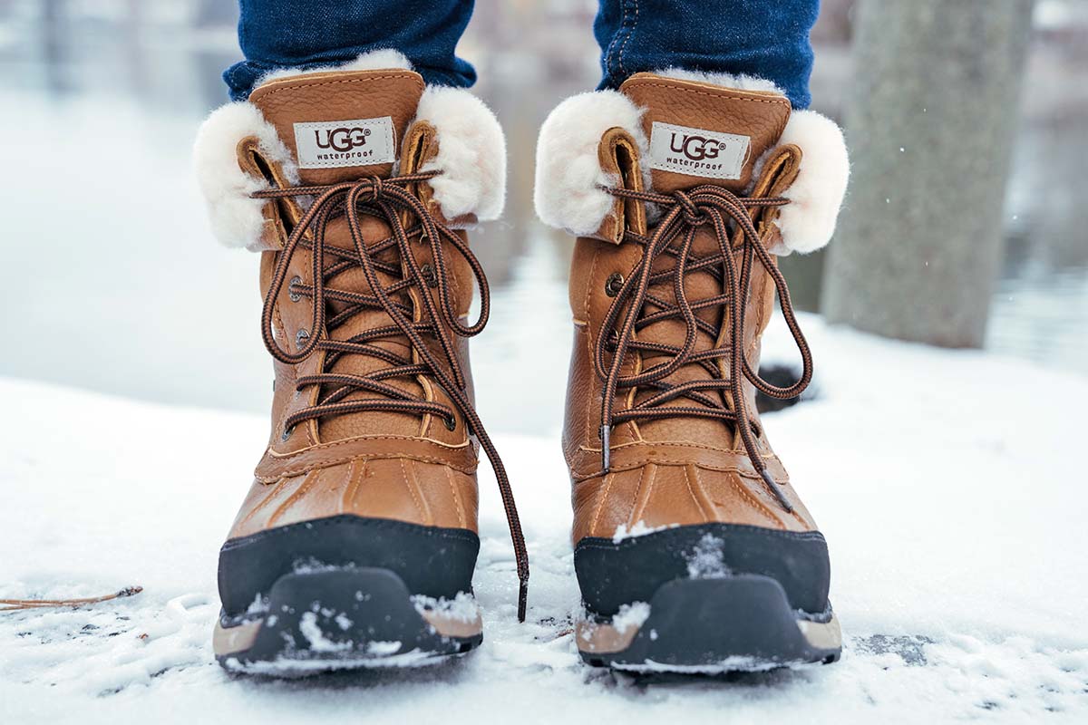 A close-up of the UGG Adirondack III winter boot on snowy ground