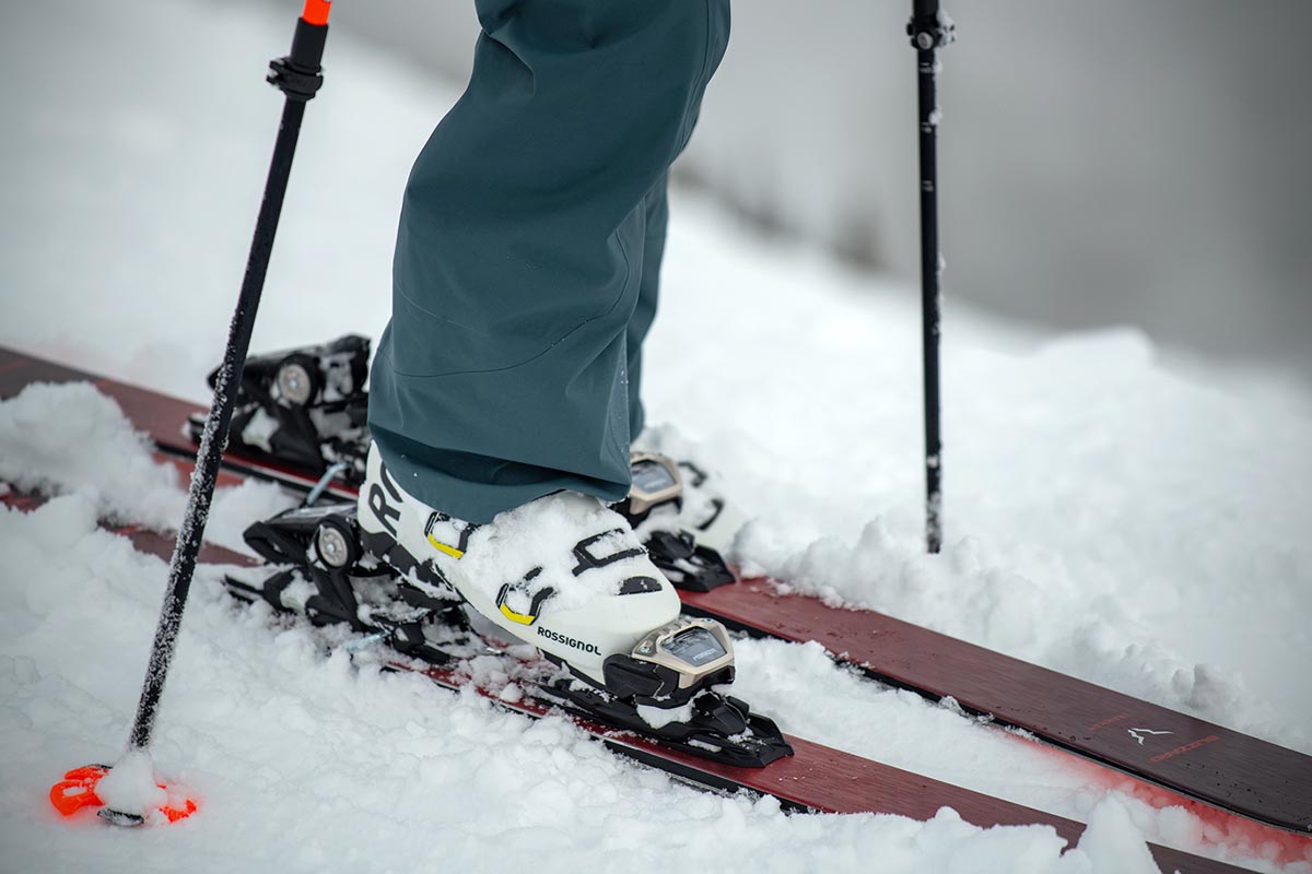 A close up of a pair of ski boots clipped into skis.