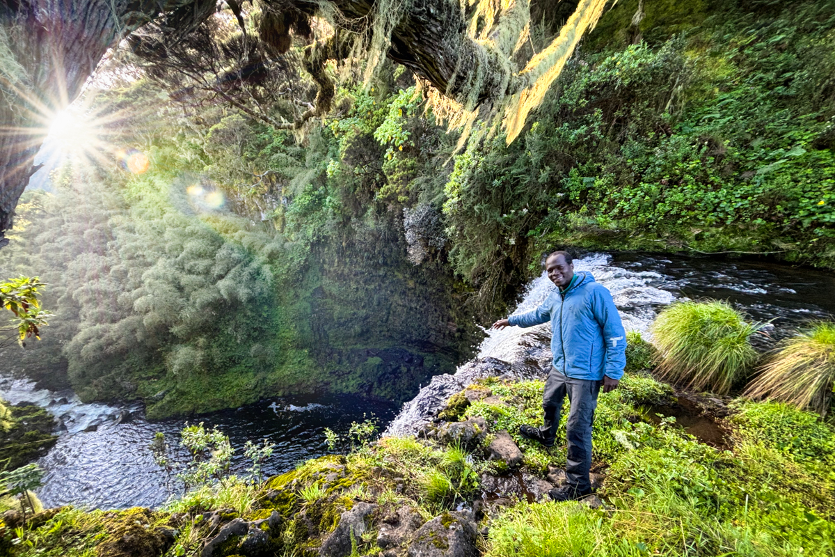 Martin poses next to a huge waterfall on the Gura River