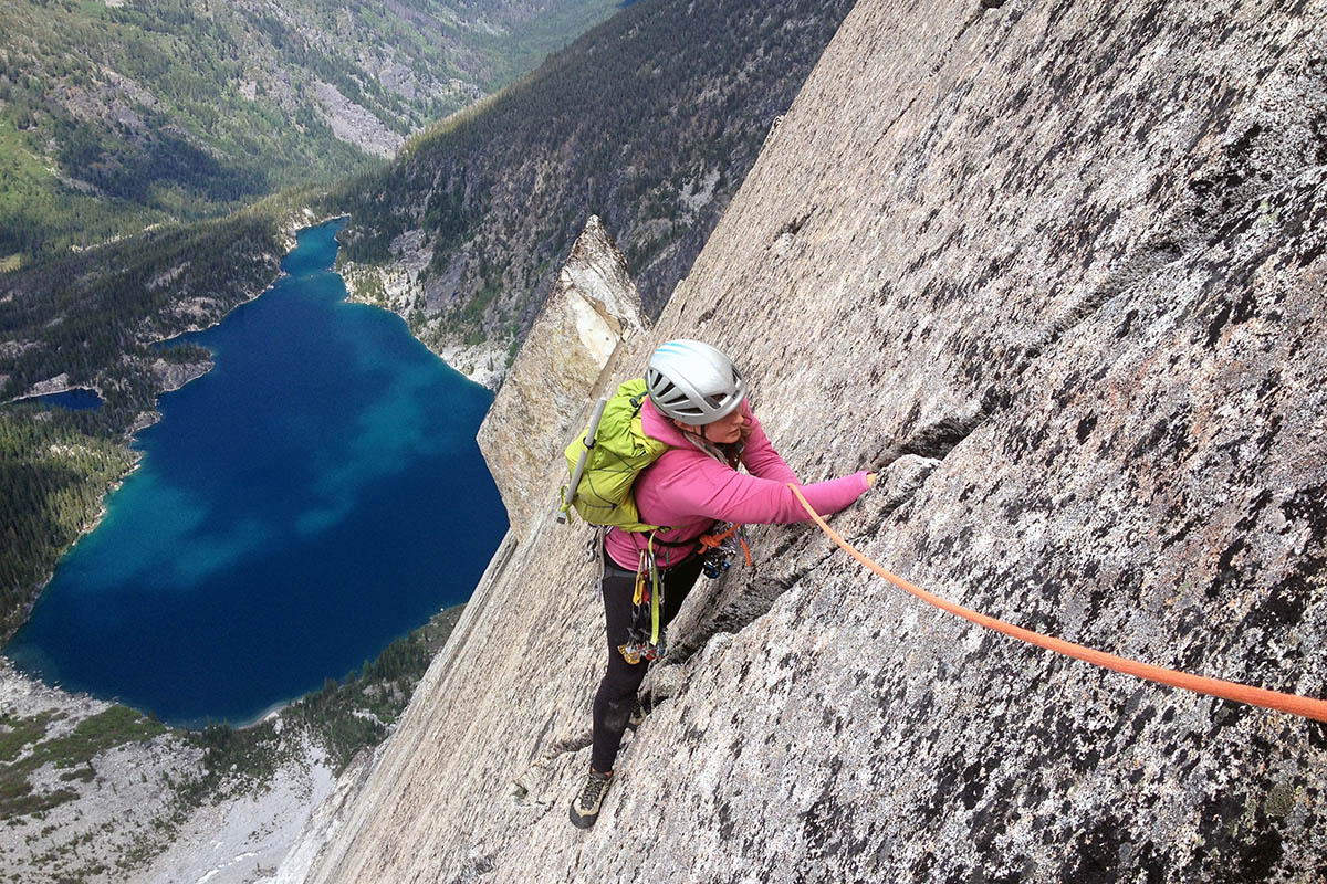 A women following a climbing route while wearing a climbing backpack