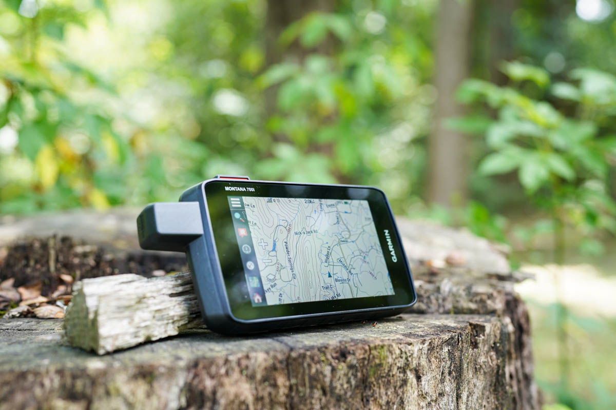 The Garmin Montana 700i sitting on a tree stump with a map displayed