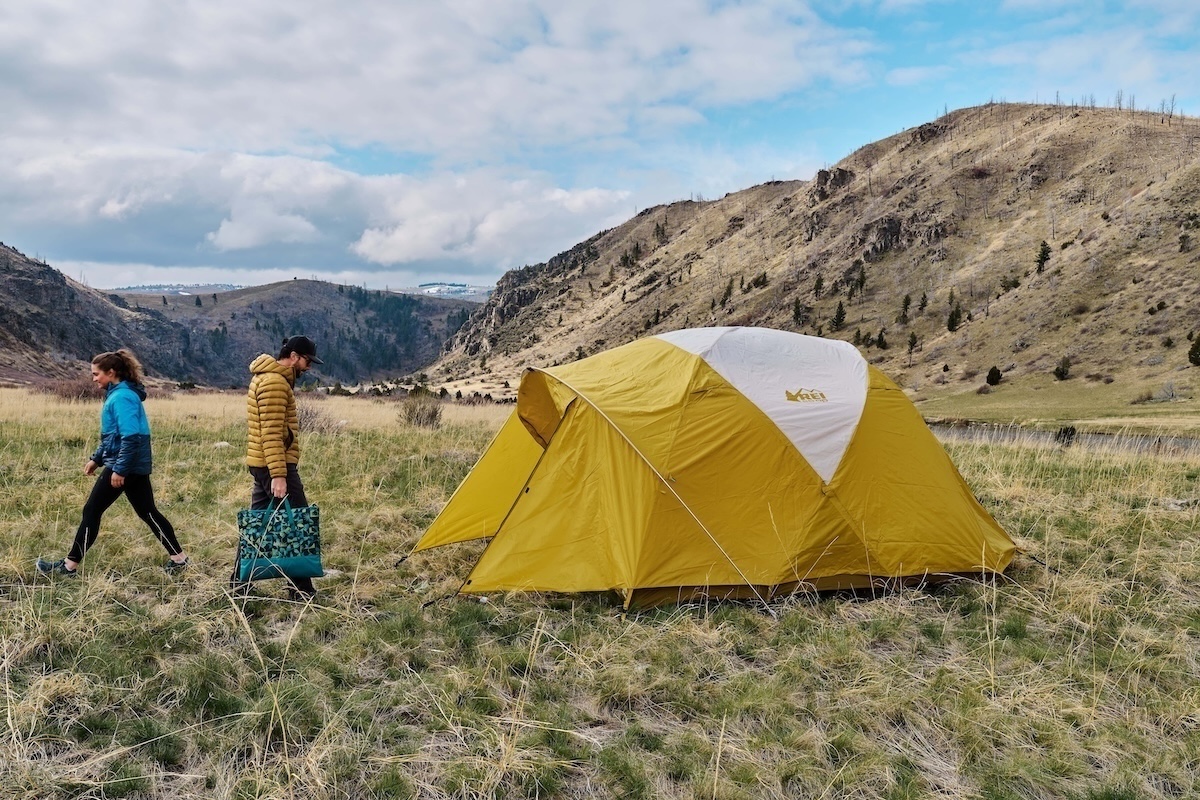 Setting up the REI Base Camp 6 tent in a field while camping in Montana