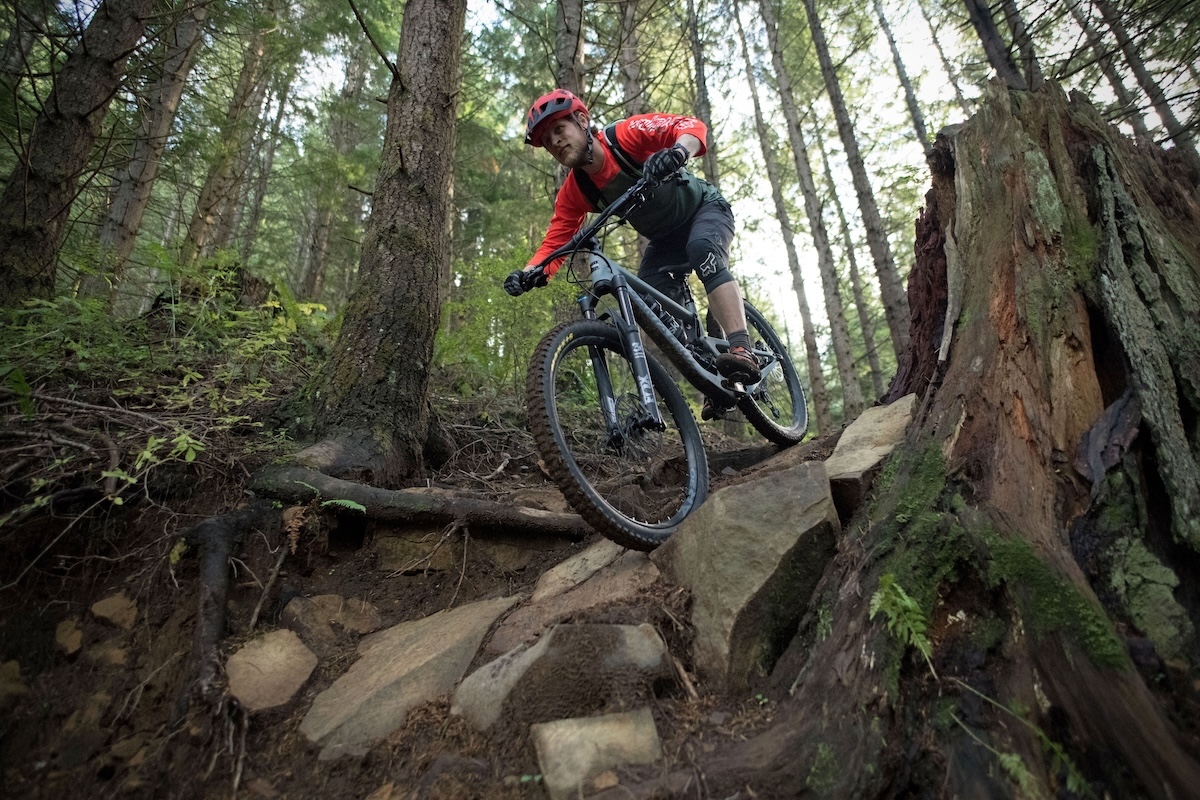 The Santa Cruz Bronson mountain bike coming downhill over some rocks