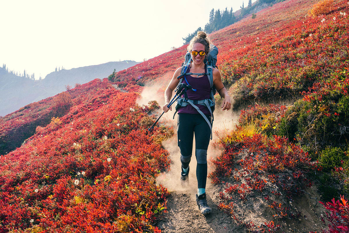A woman runs downhill wearing the Fjallraven Abisko legging