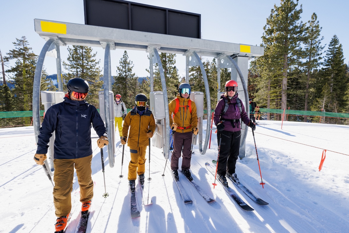 A group of skiers moving through a lift line