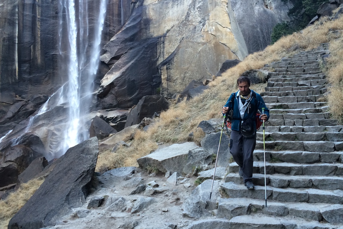 A hiker walks down rock-carved during a backcountry excursion in Yosemite Valley.